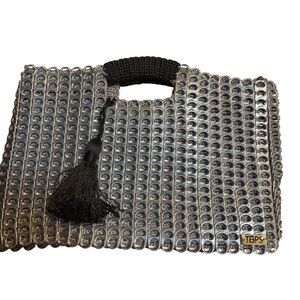 handbag made from recycled aluminum can tabs, typically a "pop top bag